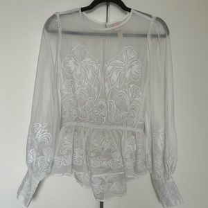 Sheer white blouse with open back